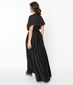 This 1970s style maxi dress is crafted in a lovely black stretch knit. Outfitted with a cutout neckline and a majestic attached capelet, that accents the dramatic pleated maxi length skirt. Complete with a back collar closure and back zipper!Available in sizes XS-4X while supplies last. 70s Disco Outfit, 1970s Clothing, Plus Size Cocktail Dresses, Plus Size Prom, Dress Unique, Knit Maxi Dress, Womens Vintage Dresses, Guest Attire, Timeless Classic Style