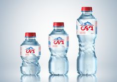 three bottled water bottles with red caps on the top and bottom, one is empty