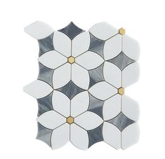 a white and black flower tile with gold accents on the bottom, in an irregular pattern