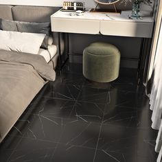 a bedroom with black flooring and a white table topped with a round ottoman next to a bed