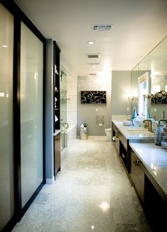 a large bathroom with two sinks and mirrors