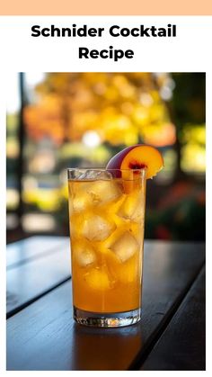 a glass filled with ice and an orange slice on top of a table next to a window