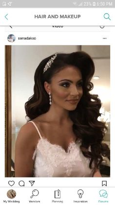 a woman with long hair wearing a tiara and looking at the camera while standing in front of a mirror