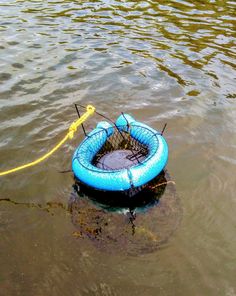 an inflatable raft floating on top of a body of water next to a yellow rope