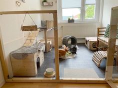 a room filled with lots of wooden furniture and animals in the window sills