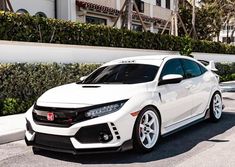 a white car parked in front of a building