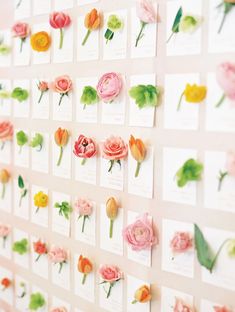 the wall is covered with flowers and cards for each individual to place on it's own