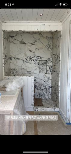 an empty room with marble walls and floors