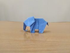 an origami elephant on a wooden table