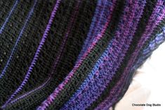 there is a purple and black knitted blanket