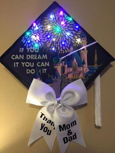 a graduation cap with lights on it and a ribbon that says, if you can dream it you can do it