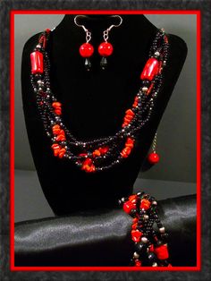 "3 piece handmade red and black braided jewelry set. Set includes necklace, bracelet, and earrings. 6 strand braided necklace includes red chipped stones, red with black swirl glass beads, and red, black and silver seed beads. Shepherds hook closure and large silver chain loops allow necklace to be adjustable from 20\" to 25\" long with weighted tail. Matching 3 strand braided bracelet with toggle clasp. 2\" long and ½\" wide drop earrings with 1\" fish hooks.  Hypo-allergenic fish hooks availab Red And Black Beaded Necklaces, Black Multi-strand Costume Jewelry, Adjustable Red Jewelry With Black Beads, Unique Red Multi-strand Jewelry, Black Multi-strand Jewelry For Gift, Adjustable Black Czech Glass Jewelry, 6 Strand Braids, Braided Jewelry, Braid Jewelry