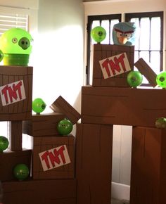 angry birds made out of cardboard boxes sitting on top of each other in front of a window