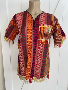 This pretty huipil top is from Guatemala. It is traditional weave fabric with a simple home made styling.  Please check measurements before purchasing - I believe this is a woman S/XS or a youth Large..   All measurements are laying flat: underarm to underarm/bust - 20.5", waist 19.5", hips - 2" and length from shoulder to hem is 26". FREE shipping in the USA.  This is for shipping with Delivery Confirmation.�  ALL FUNDS MUST BE PAID IN US DOLLARS. Buyer to pay Weave Fabric, Simple Home, Us Dollars, Simple House, Home Made, Traditional Outfits, Guatemala, Priority Mail, Woven Fabric