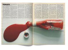 an open magazine with a red bottle on it