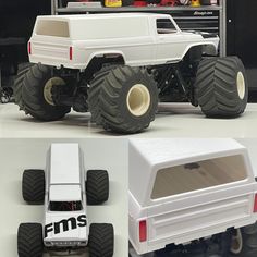 a white truck with big wheels and tires on display