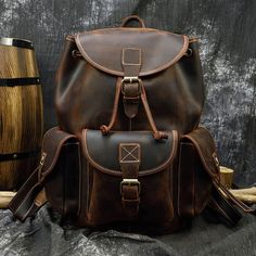 Premium Material: Crafted from 100% Genuine Leather, this backpack features Crazy Horse full grain top layer leather, known for its rich, rugged appearance, and exceptional durability. 🌲 The use of Crazy Horse leather adds a touch of adventure and robust elegance to the backpack. Classic Color Choices: Available in Brown and Dark Brown, these timeless color options suit various styles and preferences. 🎨 The classic color choices ensure versatility, making it easy to complement different outfit Luxury Brown Leather Backpack For Men, Luxury Brown Backpack With Gold-tone Hardware, Leather Travel Backpack, Popular Backpacks, Leather Backpack For Men, Vintage Elements, Leather Backpacks, Laptop Rucksack, Retro Men