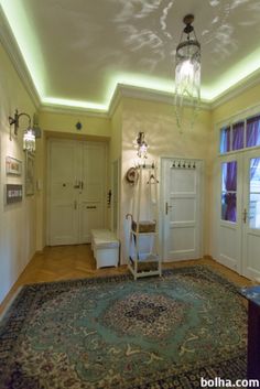 a living room filled with furniture and a chandelier