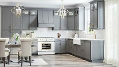 a kitchen filled with lots of gray cabinets and white counter tops next to a dining room table