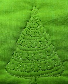 a green piece of cloth with a christmas tree on it