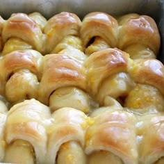 a baking dish filled with bread wrapped in cheese