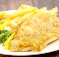 a white plate topped with chicken, potatoes and broccoli