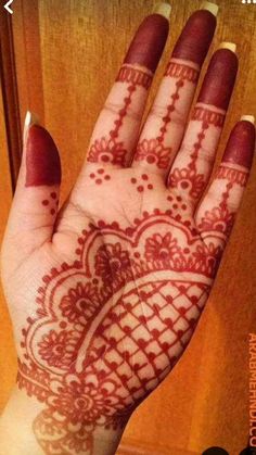 the hand is decorated with henna designs