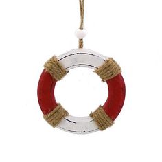 a red and white life preserver hanging from a rope