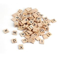 wooden alphabets are scattered on top of each other, with letters spelling out the word