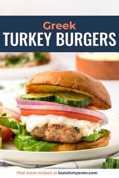 a turkey burger on a plate with lettuce and tomatoes