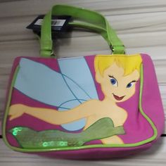 This Magical Disney Shoulder Bag Is Perfect For Any Little Girl Who Loves Fairies And Stars. Featuring Tinkerbell, The Bag Has A Solid Pattern With Pink And Green Colors And Is Made Of Canvas And Blended Fabric. The Top Closure Keeps All Items Safe, And There Is Even An Inside Pocket For Extra Storage. The Bag Can Be Used For Parties Or Casual Outings, And Its Small Size And Top Handle Make It Easy For Little Hands To Carry. With Sequin Accents And A Vintage Touch, It's A Designer Piece That Any Pink Character Bag For Disney Trips, Character Style Pink Bag For Disney Trips, Playful Pink Bag For Disney Trips, Vintage Tinkerbell, Elsa Pink, Soft School, Magical Theme, Tinkerbell Fairy, Mickey Mouse Backpack