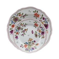 three plates with floral designs on them, one is white and the other is pink