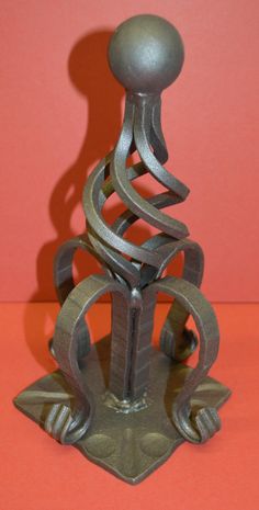 a metal sculpture on an orange surface