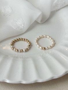 This beaded freshwater Pearl ring set adds elegance to your everyday jewelry look! Each dainty ring is hand beaded just for you! These gorgeous genuine Pearl rings are accented with sensitive skin safe 14K Gold Filled. * 3mm natural freshwater Pearls * 14K Gold Filled accent beads * Rings may be purchased as a set, or single from the drop down menu below. Extra Small ring fits US 4-5 Small ring fits US sizes 6-7 Medium ring fits US sizes 8-9 Large ring fits US sizes 10-11 See all Pearl Jewelry here!: https://etsy.me/3zMbXyh GET TO KNOW MAGBEE JEWELRY!: ✨ 🤍 All MagBee pieces are safe for sensitive skin and made with hypoallergenic Gold Filled or 925 Sterling Silver. 🤍 I only use real/natural gemstones and Pearls. 🤍 Most items are made to order just for you and have a 2-4 day processing t Stretch Rings, Beads Rings, Seed Pearl Ring, Gifts For Friend, Pearl Rings, Small Ring, Freshwater Pearl Ring, Ring Gifts, Beaded Ring