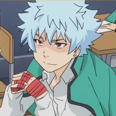 an anime character with white hair and blue eyes holding a red object in his hand