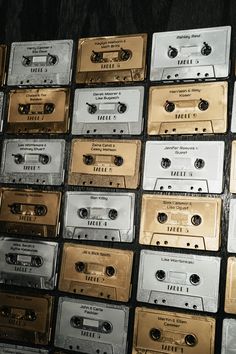 there are many old cassettes stacked on top of each other in rows, all gold and silver