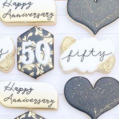 decorated cookies in the shape of heart and 50th anniversary date with happy anniversary written on them