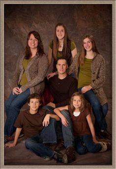 the family is posing for a photo in front of a brown background with white border