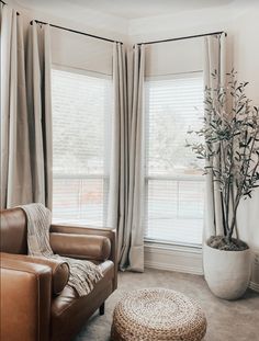 a living room with leather furniture and large windows