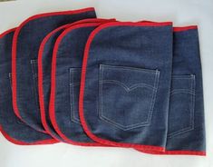 four pairs of blue jeans with red trims