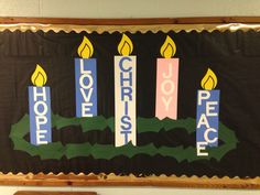 a bulletin board decorated with candles and the words love, hope, peace on it