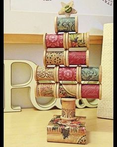 a stack of rolled up books sitting on top of a wooden table next to a white chair