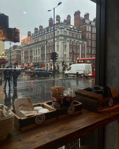 people are standing outside in the rain on a rainy day