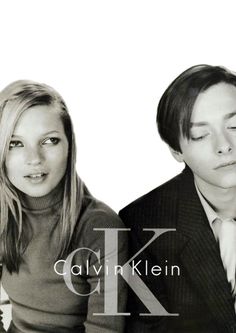 a man and woman posing for a black and white photo with the letter k on it