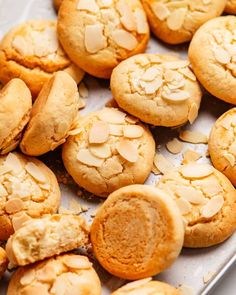 cookies with almonds on a baking sheet ready to be baked in the oven or eaten