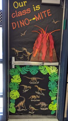 a classroom door decorated with dinosaurs and volcanos