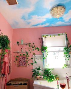 a bathroom with pink walls and painted ceiling