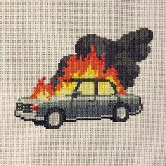 a cross stitch picture of a car on fire