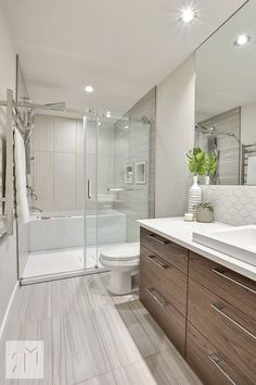 a bathroom with a sink, toilet and shower