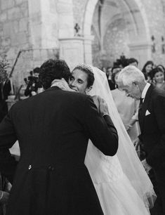 black and white photograph of a bride hugging her groom